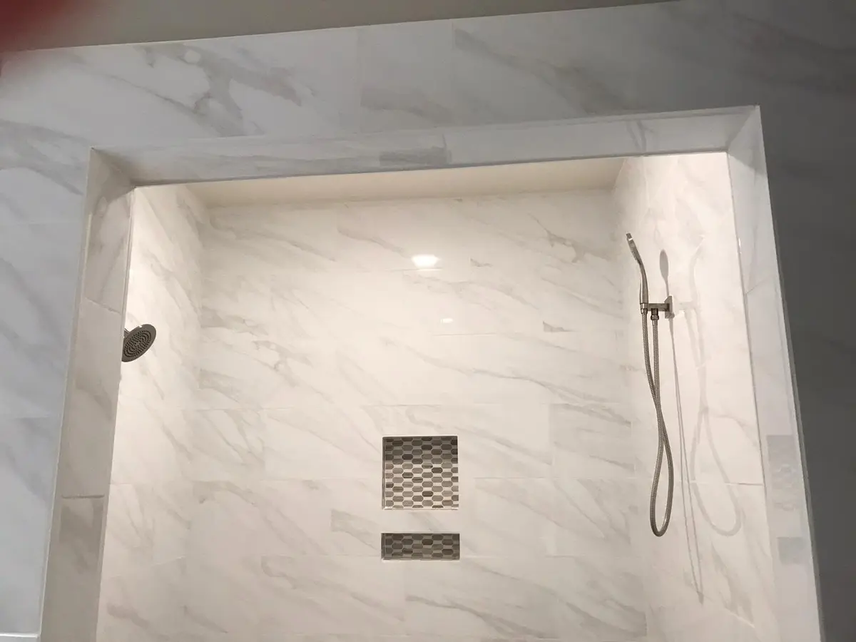 Bathroom remodeling in Vallejo: marble-look shower with recessed niche