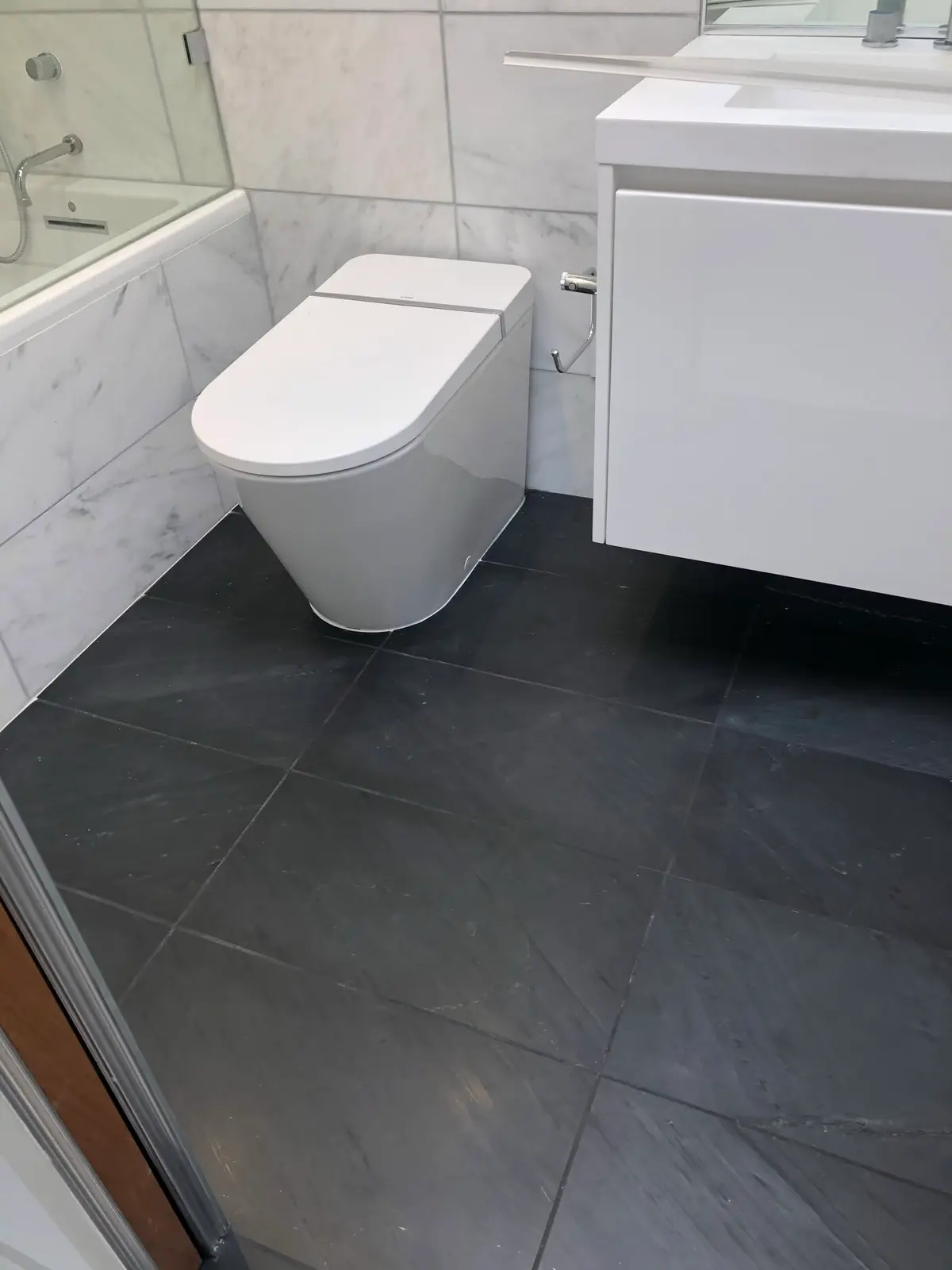 Bathroom remodeling in Vallejo: wall-hung vanity and modern toilet on slate-look floor