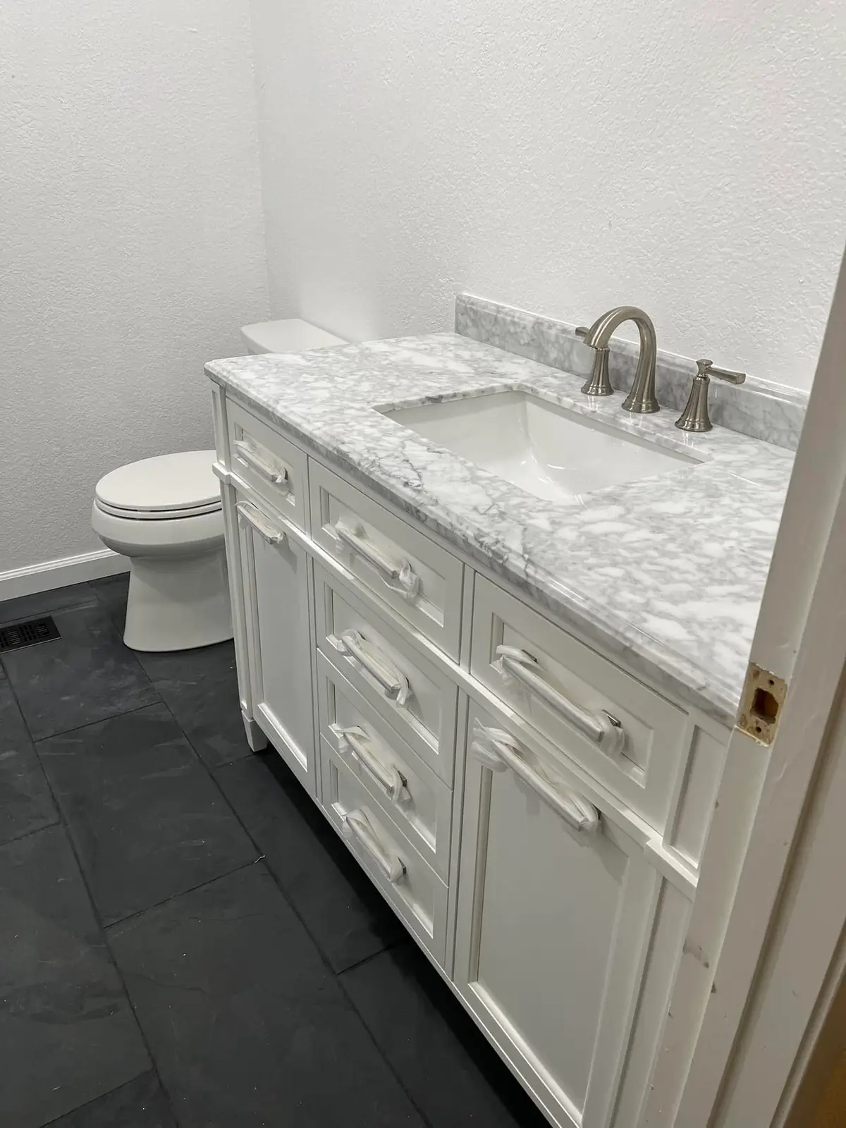Bathroom remodeling in Vallejo: white vanity with marble top
