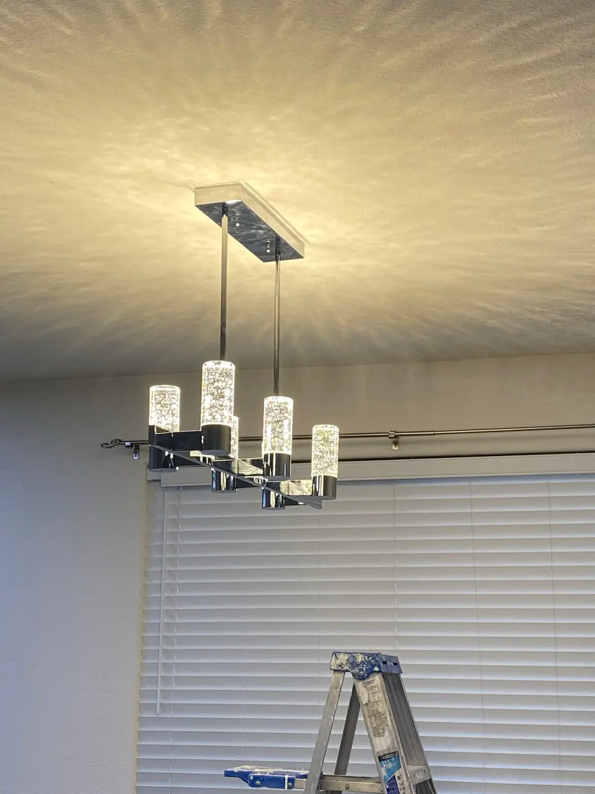 Electrician in Vallejo: linear chandelier above a window with blinds