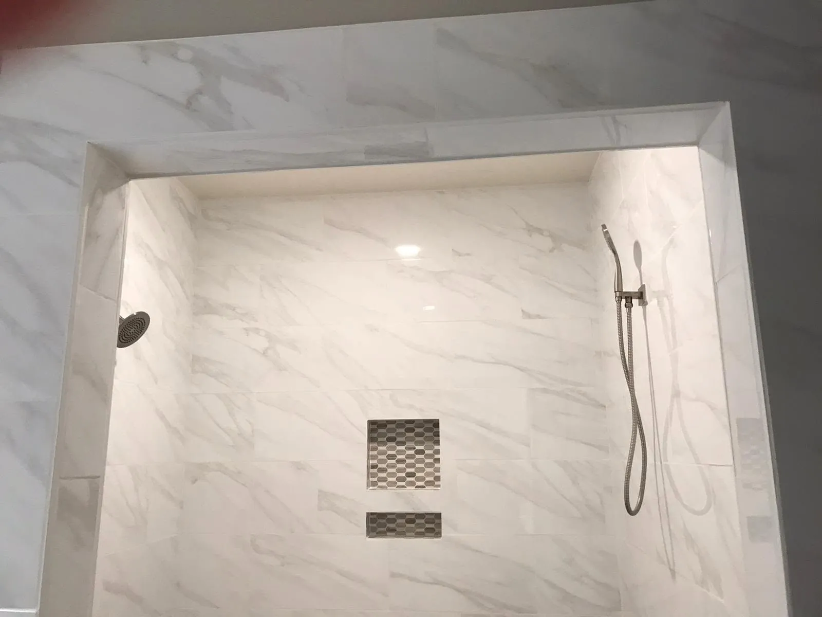 Tiled shower niche in a marble-look shower in Vallejo
