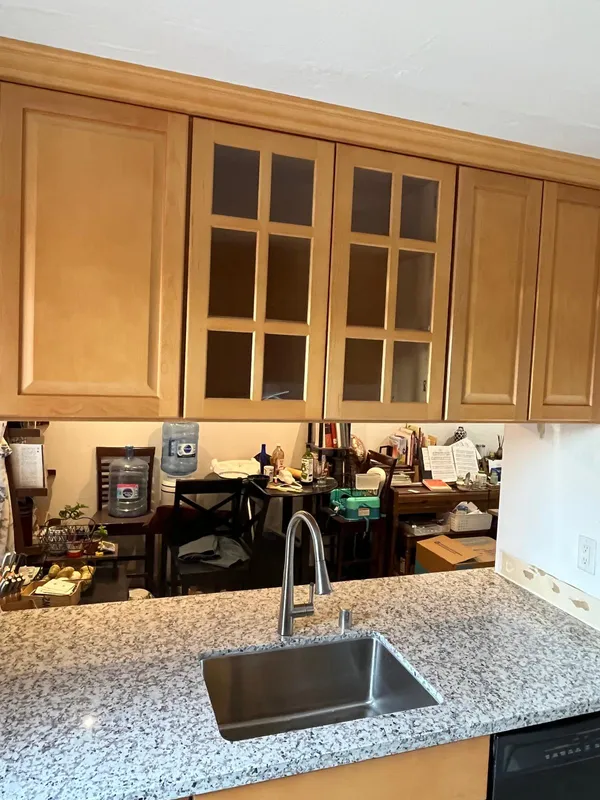 Maple cabinets with glass-front doors and granite counters in a Vallejo kitchen