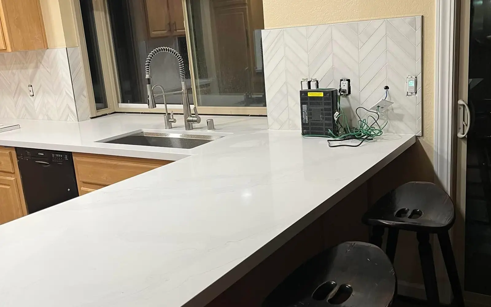 General contractor in Vallejo: finished quartz kitchen counter with herringbone tile backsplash
