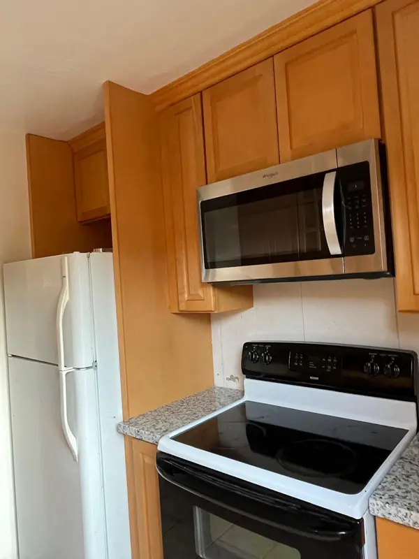 Before photo of a Vallejo kitchen with original honey oak cabinets, part of an E&MC Remodeling project