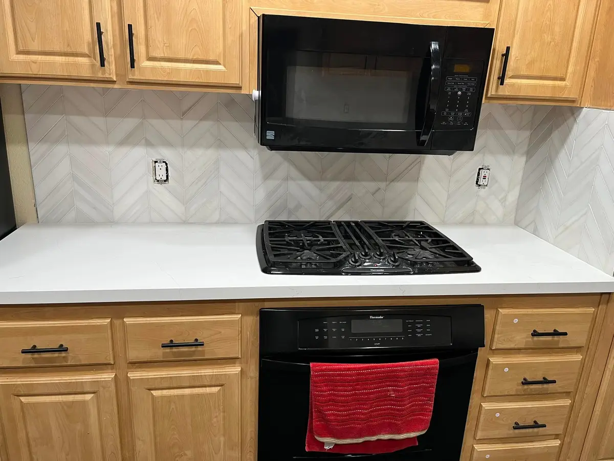 Tile contractor in Vallejo: herringbone backsplash behind cooktop