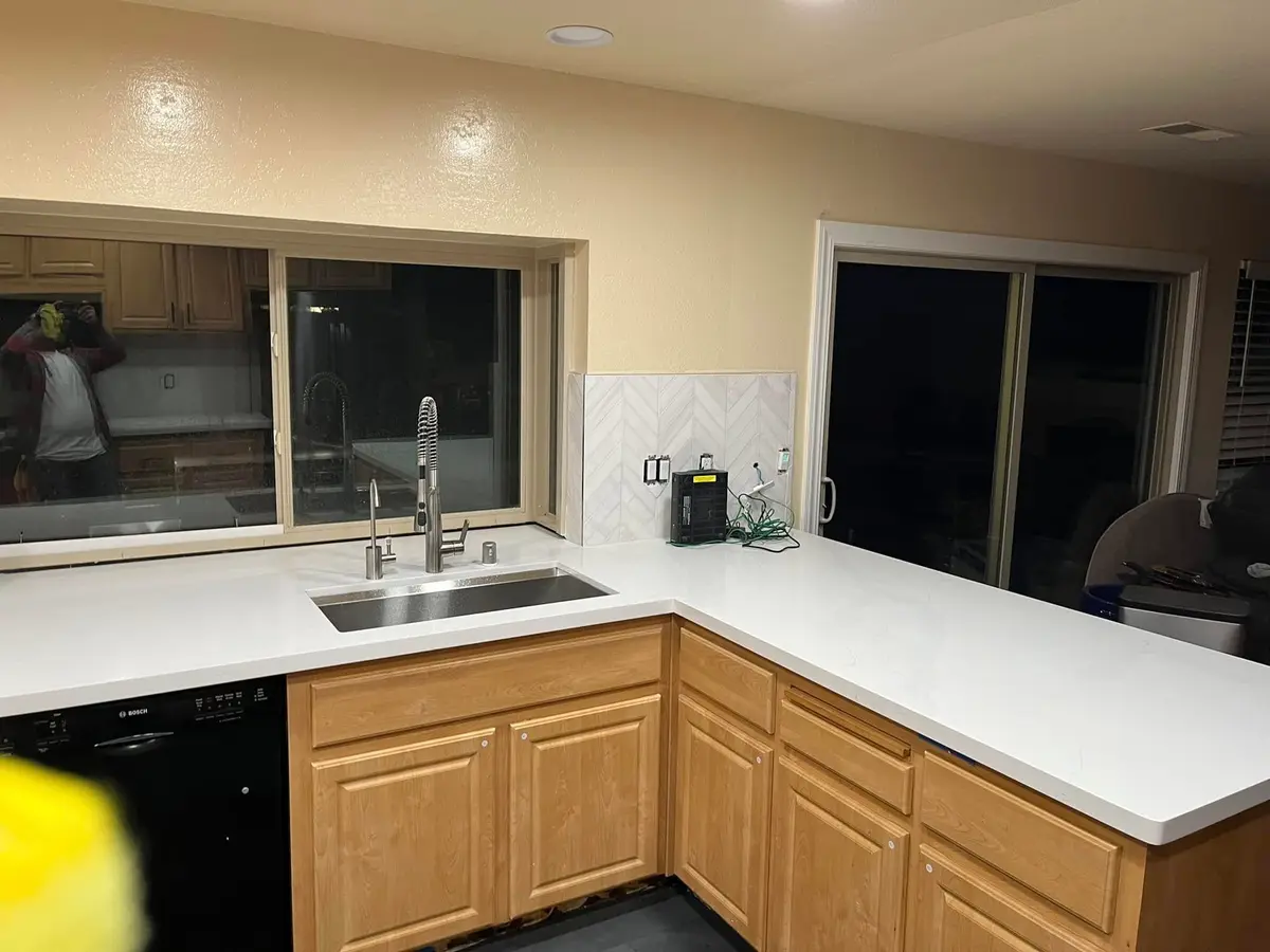 Kitchen remodeling project by E&MC Remodeling in Vallejo with white quartz counter and undermount sink