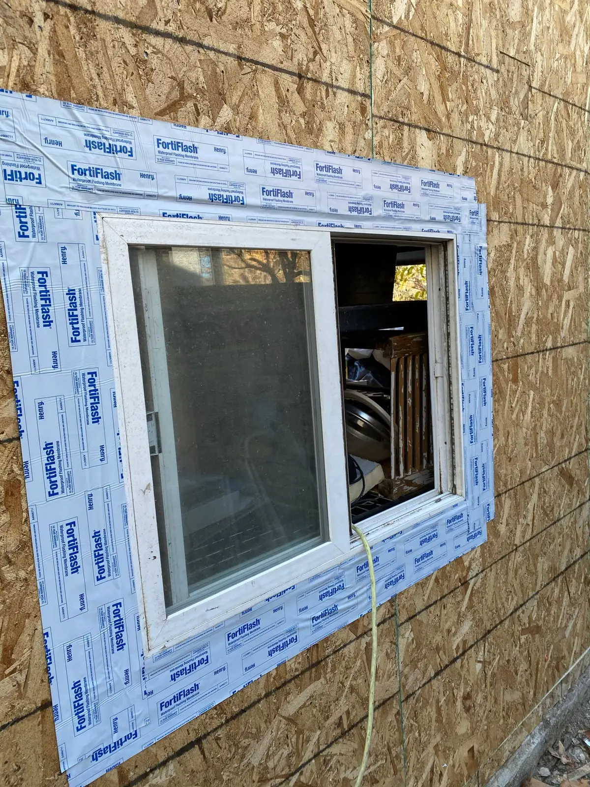 Window installation in Vallejo with flashing tape sealing a new window in the frame